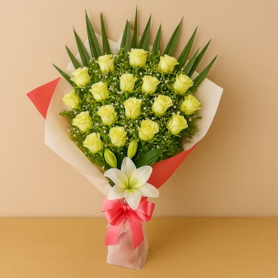 Ramo Rosas Amarillas con lirio blanco, gypsophila, follaje verde, envoltura blanca y roja, y lazo rosa satinado, sobre fondo beige y mesa clara. Composición vertical, luminosa y armoniosa.